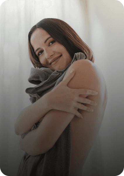 Woman smiling, embracing herself